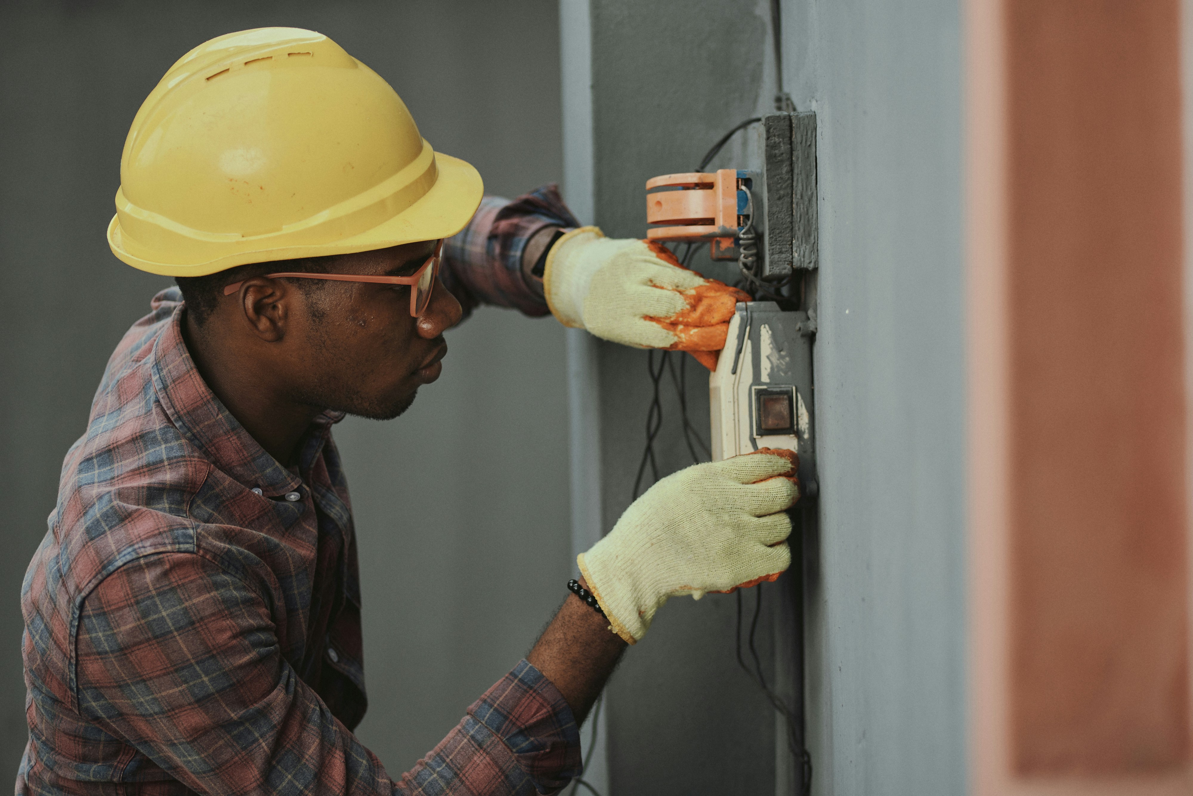 Professional electrician working on an electrical panel